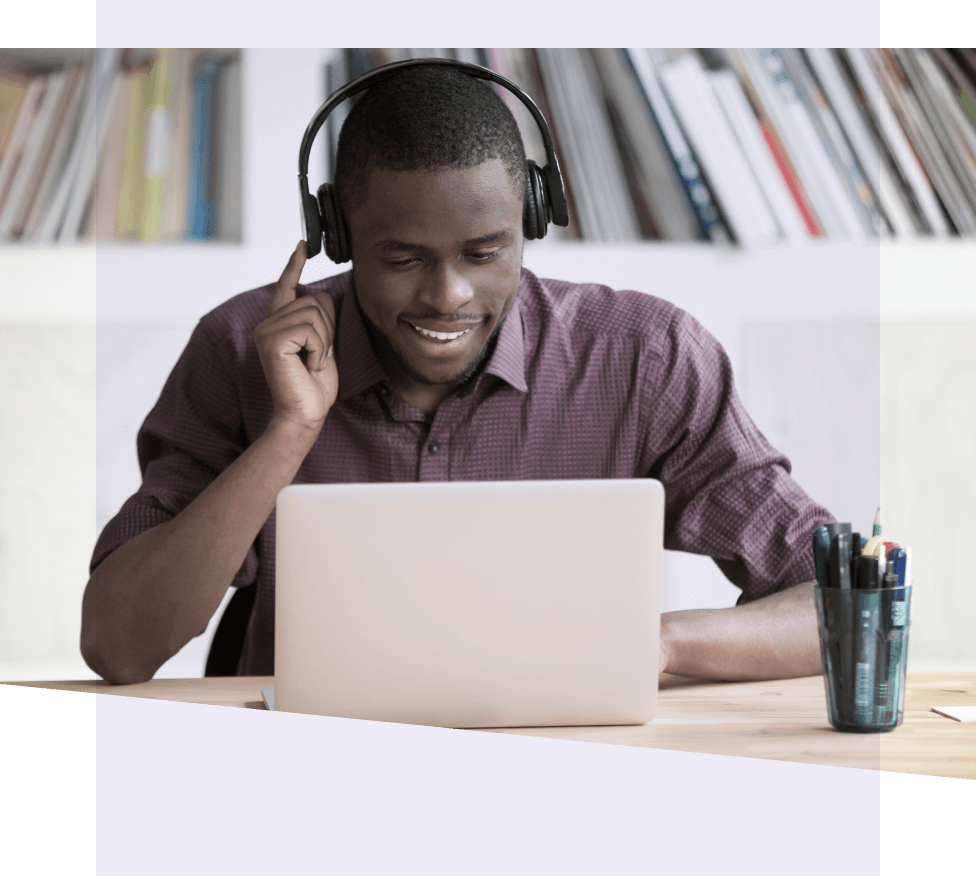 Man wearing headphones working on a laptop