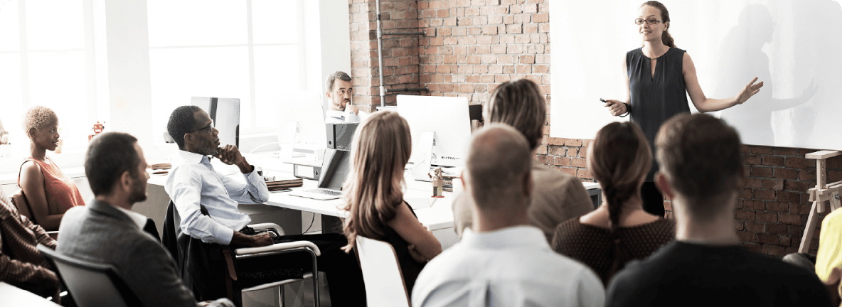 A group of people listening to a tutor